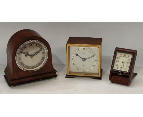 A mahogany Elliot clock, 11cm; another domed miniature mantel clock; a folding travel clock (3) 