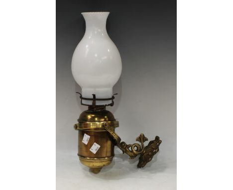 Maritime interest - an early 20th century brass ships bulkhead/wall mounted oil lamp, gimballed mount, cast brass coiled fish
