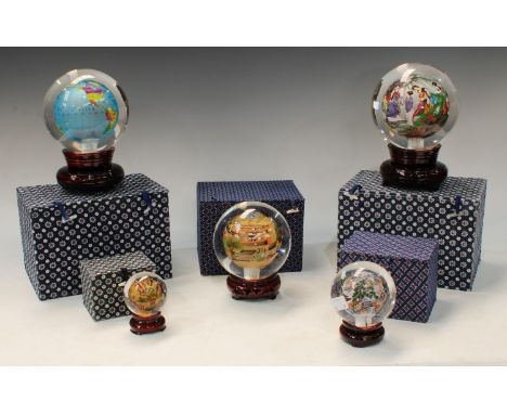 A Chinese reverse painted sphere, globe of the world, on hardwood stand, 19cm overall, boxed; a set of four graduated Chinese