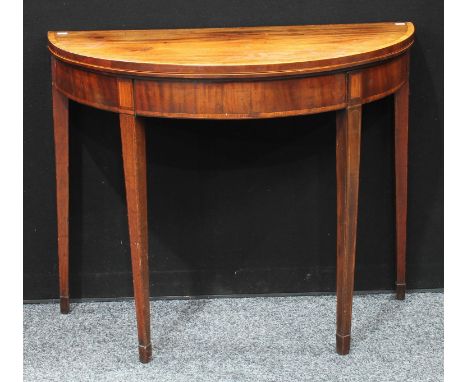 A George III mahogany demilune card table, hinged crossbanded top enclosing an inset baize lined playing surface, above a dee