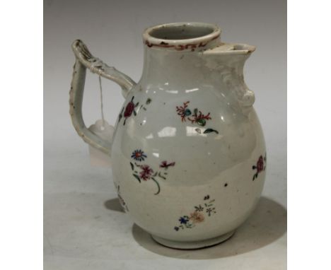 An 18th century Chinese chocolate pot, for the continental market, decorated with foliate sprigs in the famille rose palette,