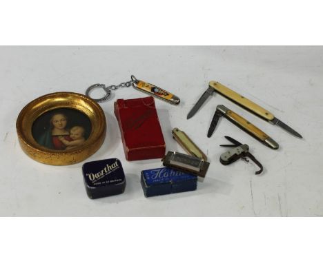 A miniature Owzat game, boxed; a miniature harmonica, boxed; a miniature pocket knife; others; a napkin ring; qty 