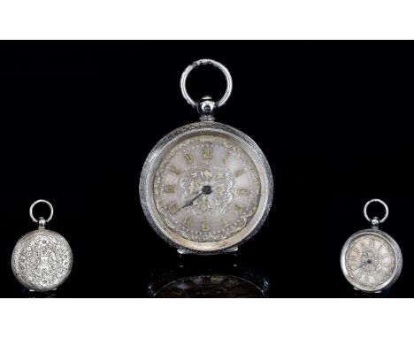A Ladies Edwardian Fobwatch Silver dial, keywind watch with central cross detail and gold tone Roman numerals to face. Etched