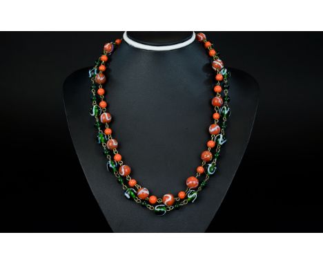 A Pair Of 1920's Handmade Glass Bead Necklaces Two in total each comprising striated glass beads strung on brass tone wire se
