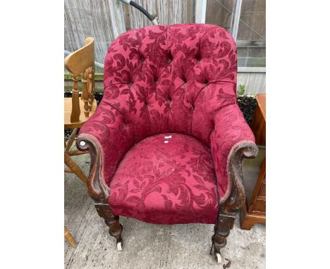 A VICTORIAN MAHOGANY EASY CHAIR WITH BUTTON BACK, SWEPT ARMS AND PORCELAIN CASTERS 