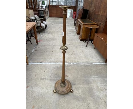 A VICTORIAN STYLE BEECH STANDARD LAMP WITH BRASS FITTINGS AND CLAW FEET 