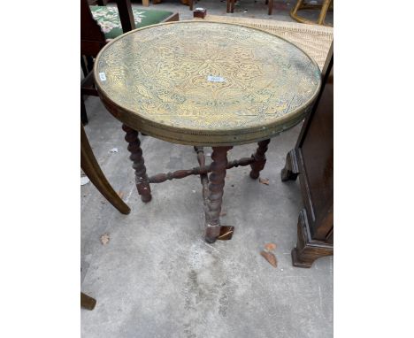 AN INDIAN BRASS COFFEE TABLE ON FOLDING BASE 