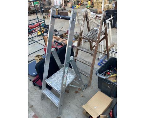 AN ALUMINIUM WHEELED STEP AND A VINTAGE THREE RUNG WOODEN STEP LADDER 