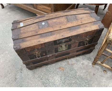 AN EDWARDIAN DOME TOP TRUNK 