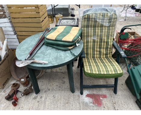 A PLASTIC GARDEN TABLE AND A FOLDING CHAIR 