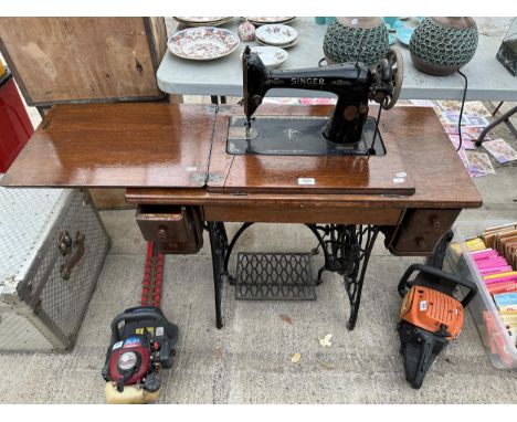 A VINTAGE SINGER SEWING MACHINE WITH OAK TABLE AND TREADLE BASE 