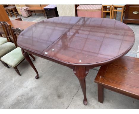 A MAHOGANY EXTENDING DINING TABLE ON CABRIOLE LEGS 