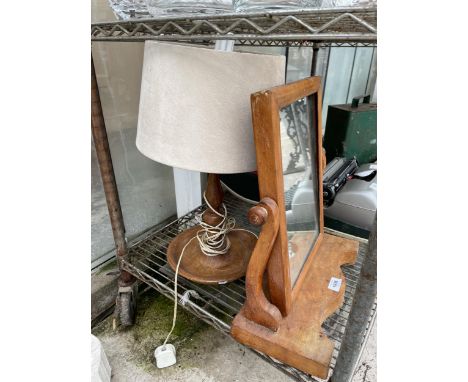 AN OAK SWING FRAME DRESSING TABLE MIRROR AND A DECORATIVE OAK TABLE LAMP 