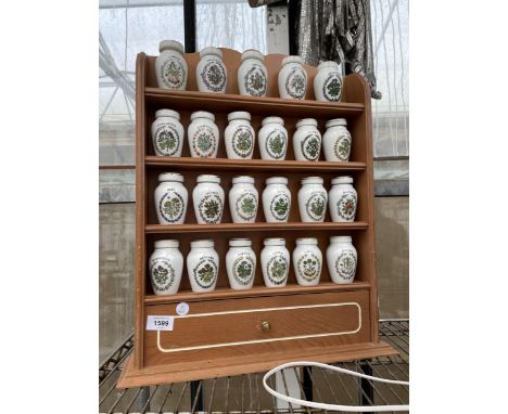 A WOODEN SPICE RACK WITH LOWER DRAWERS AND 23 GLORIA CONCEPTS THE FRANKLIN MINT LIDDED SPICE JARS 