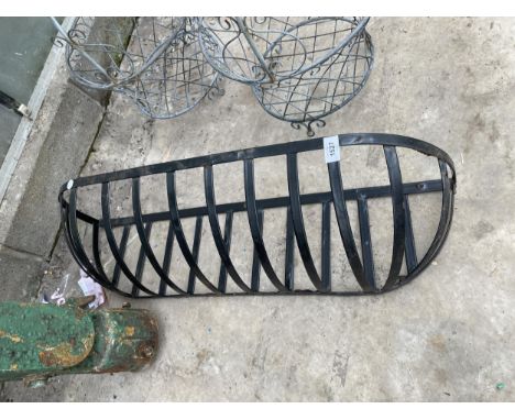 A SMALL METAL HAYRACK PLANTER 