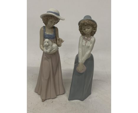 TWO NAO FIGURES OF GIRLS TO INCLUDE ONE HOLDING A PUPPY 