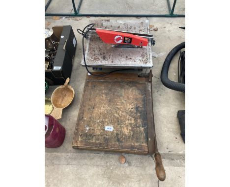 AN ELECTRIC TILE CUTTER AND A VINTAGE GILOTINE 