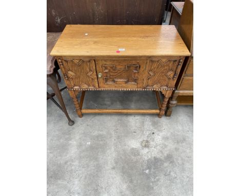 AN OAK JACOBEAN STYLE RAYSWI SIDE CABINET ON BOBBIN TURNED LEGS 36" WIDE 