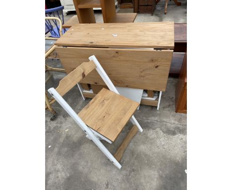 A MODERN PINE DROP-LEAF KITCHEN TABLE ENCLOSING FOUR FOLDING CHAIRS 