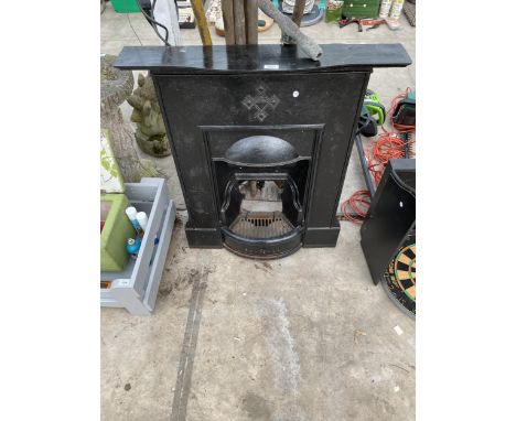 A DECORATIVE CAST IRON FIRE SURROUND AND GRATE 