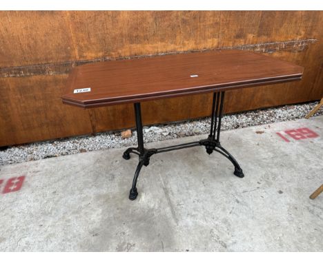 A MAHOGANY PUB TABLE WITH CANTED CORNERS ON A CAST IRON BASE 51" X 30" 