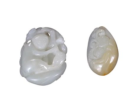 A late 19th / early 20th century Chinese carved jade pendant and a later example, largest 5cm.  Condition - good