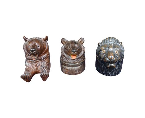 Three Black Forest carved wood novelty inkwells with glass and ceramic liners, one in the form of a lion, largest 9cm high. C