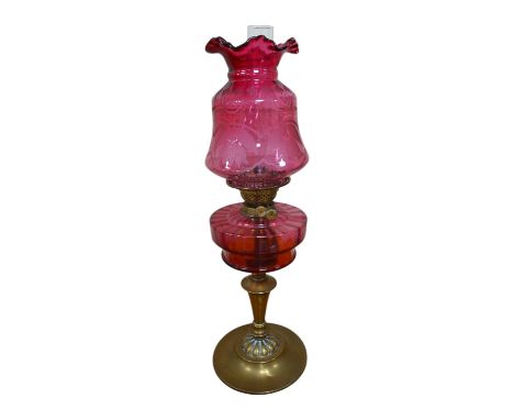 A Victorian oil lamp on brass base with cranberry font, acid etched cranberry shade chimney, overall 62cm high. Condition - g