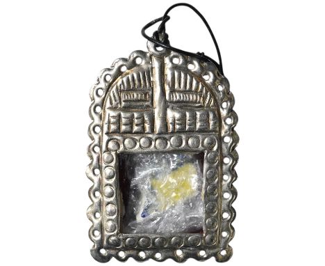 A Grayson Perry reliquary white metal pendant containing a section of tile, with Tate box, 7.5cm high. Condition - good