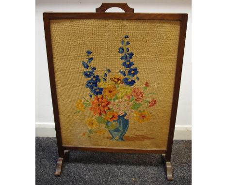 An oak framed woolwork firescreen