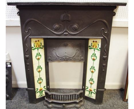 A reproduction Art Nouveau style cast iron fire surround with ceramic tiles