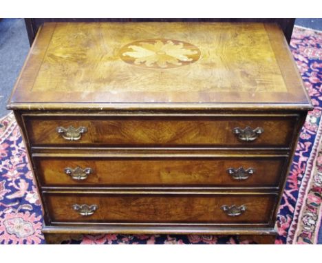 A reproduction low chest of three long burr walnut and mahogany cross banded drawers, bracket feet, satinwood inlaid patera, 