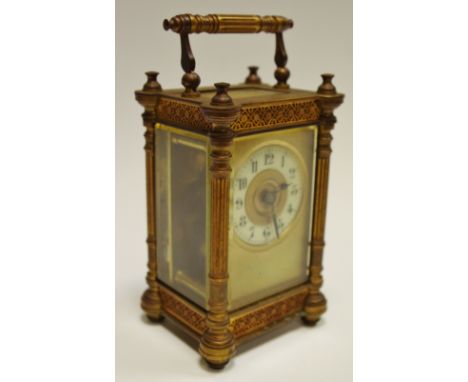 A late 19th century French carriage clock, ornate cast gilt brass case, cream ring dial, Arabic numerals, key wind movement, 
