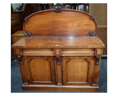 A Victorian mahogany sideboard, shaped half gallery above a pair of frieze drawers and two panel doors enclosing a shelf, pli