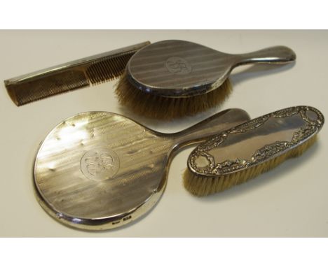 A silver back dressing table set comprising hand brush, mirror, another brush and comb, hallmarked Chester (4)