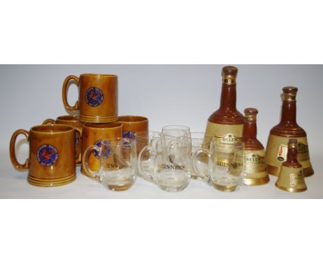 A Bell's blended Scotch Whisky Wade decanter and contents, three others, smaller, graduated; a set of six Guinness mugs; five