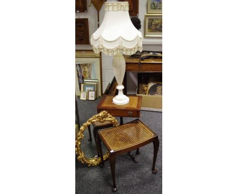 A substantial alabaster lamp base; reproduction tooled leather inlaid occasional table; rattan piano stool and ornate mirror 