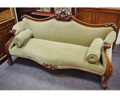 A Victorian mahogany scroll arm sofa, foliate carved top rail, padded back, padded arms , scrolling terminals, serpentine pad