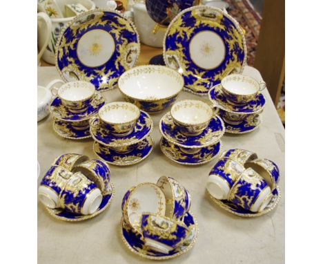 A 19th century hand painted tea service, decorated with landscape panels, gilt ,blue, cream and white scrolling swagged groun