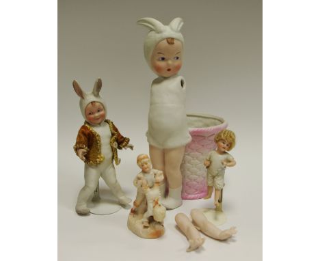 A Gerruber Heubach all bisque bunny boy, Germany 1910;  another;  a German figure group of two children playing (4)  