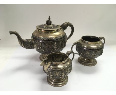 An Indian silver tea set comprising teapot, cream jug and a sugar basin. Approx 736g.