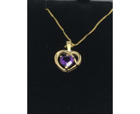 A 9ct gold amethyst pendant on a 9ct gold chain
