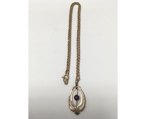 A 9 carat gold pendant set with an amethyst and attached rope chain. Weighing approximately 6.7g.