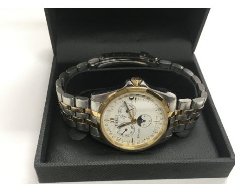 A Tissot moonphase day, date calendar watch with bi metal strap.