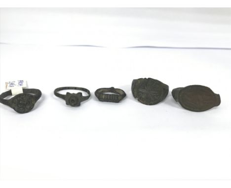Five roman rings, one is from Syria and is an example of a late Roman piece. One is a large signet ring with a flower clearly
