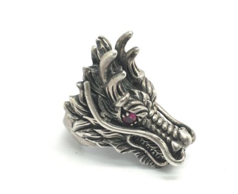 A vintage heavy silver ring in the form of a dragon's head with ruby eyes, approx size W-X.