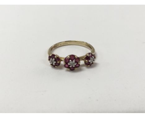 A gold ring set with three patterns of small rubies and diamonds. Approximate ring size is L.