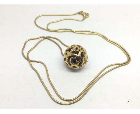 A silver gilt necklace with amethyst ball pendant.