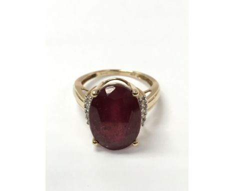 A ladies 9ct gold diamond and red stone set ring weighing approximately 5.1g and measuring approximately between ring size N 