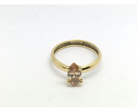 A 14ct gold ring set with a peach coloured stone, approx 1.3g and approx size N.